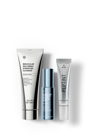 Three skincare products from Allies of Skin arranged on a white background: a tall white Molecular Silk Amino Hydrating Cleanser tube, a smaller blue serum bottle, and a white Pepint tube.